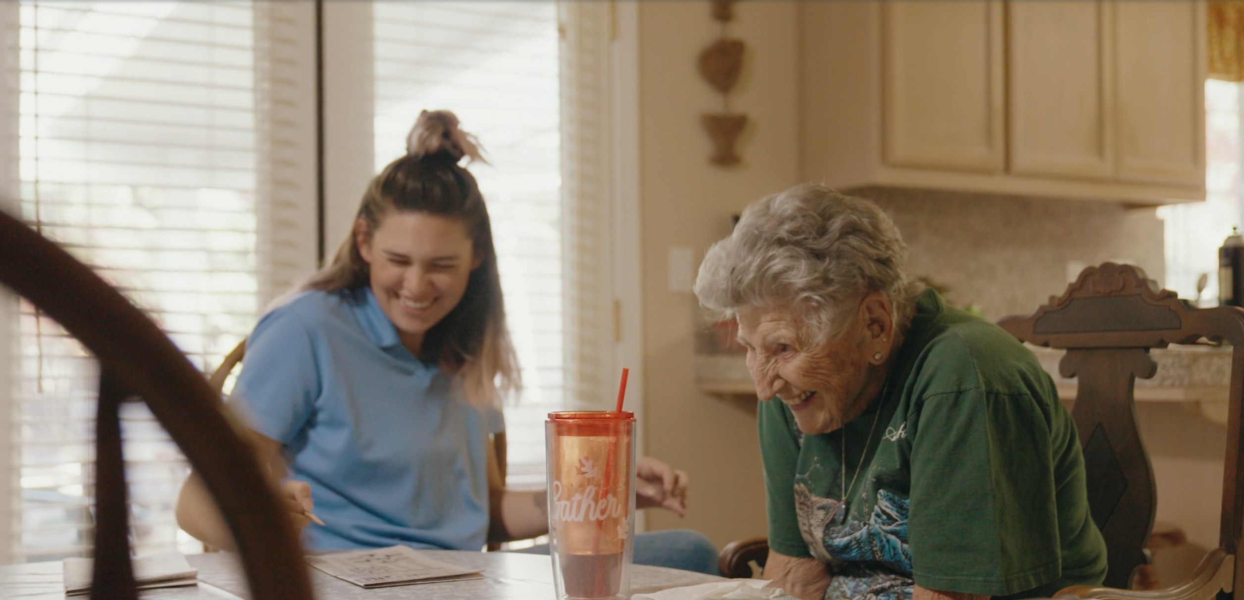 At Home Caregivers caregiver and client at the kitchen table